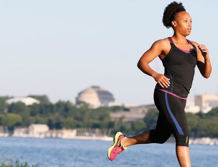 Woman running outside by waterfront