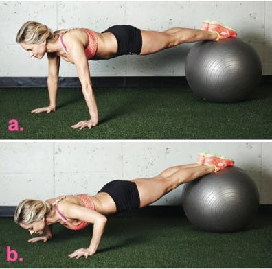 woman doing an upper body strength exercise of a push-up with her feet on an exercise ball