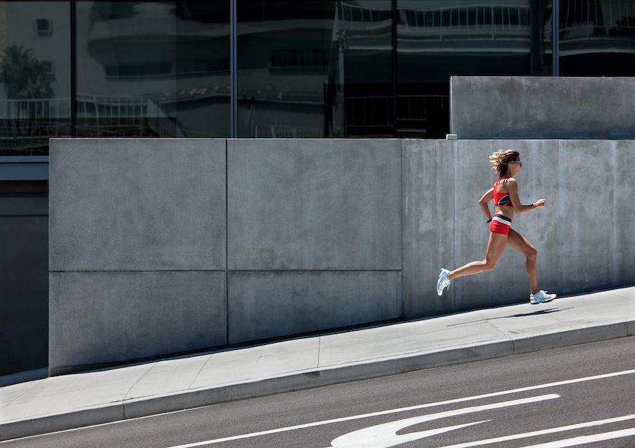 woman hill running in city