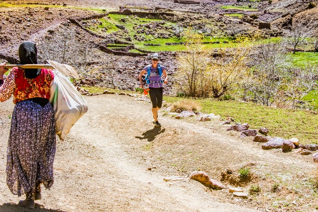 Allison runs past village women on High Atlas trail