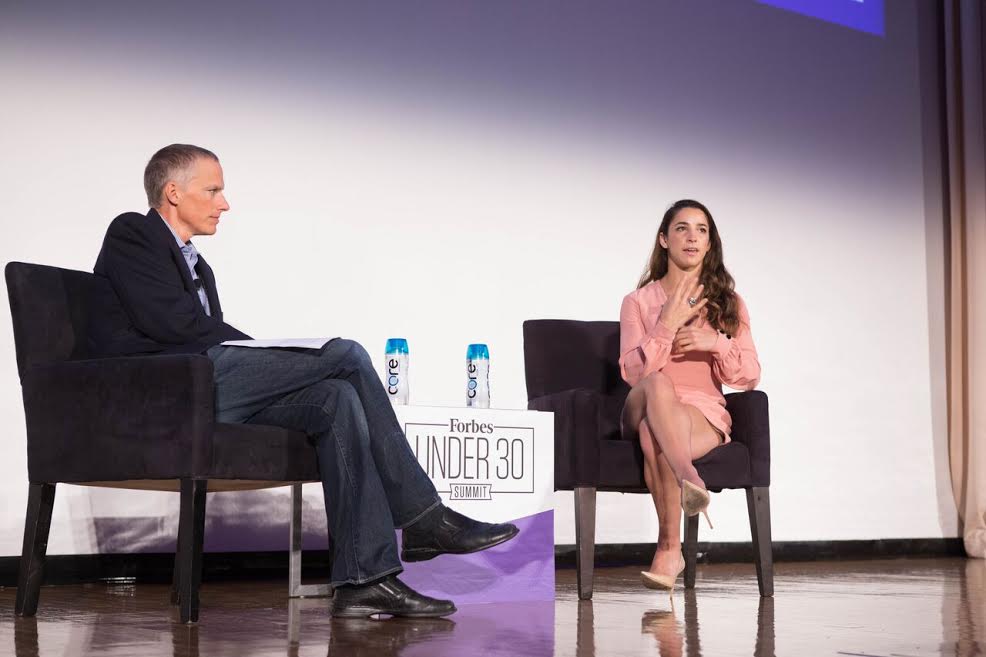 Gymnast and Olympic Gold Medalist Aly Raisman on stage with moderator Forbes Senior Editor Kurt Badenhausen at the Forbes Under 30 Summit in Boston. Photo Credit: Ian Mandt/Forbes