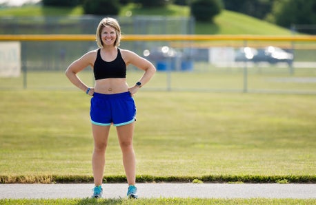 Sexy Woman Wearing Sports Bra And Short Holding A Traditional