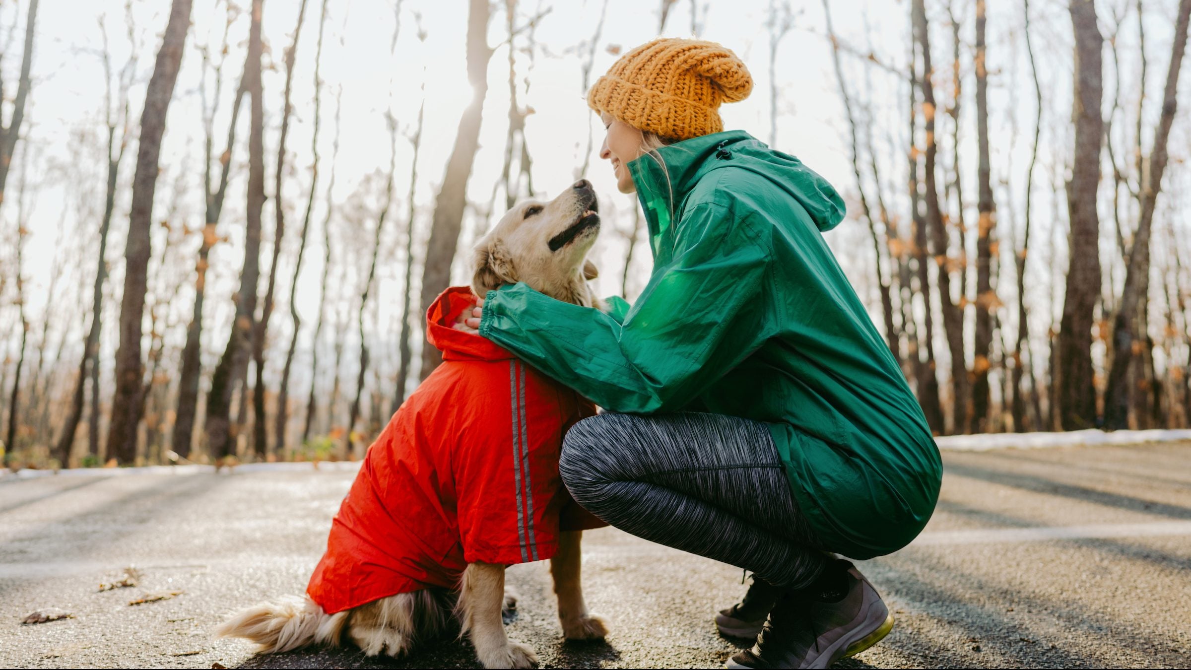woman running with dog in winter
