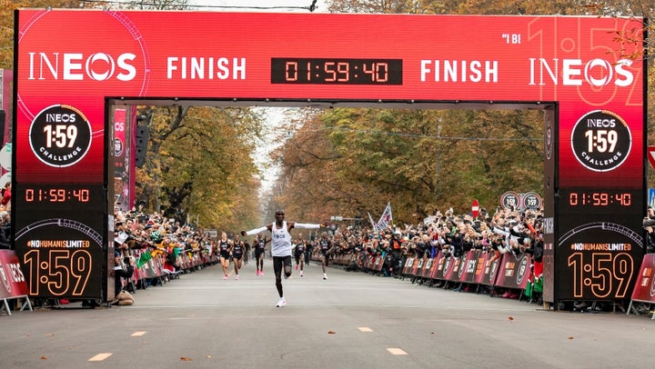 Eliud Kipchoge celebrates as he crosses finish line and makes history to become the first human being to run a marathon in under 2 hours.
