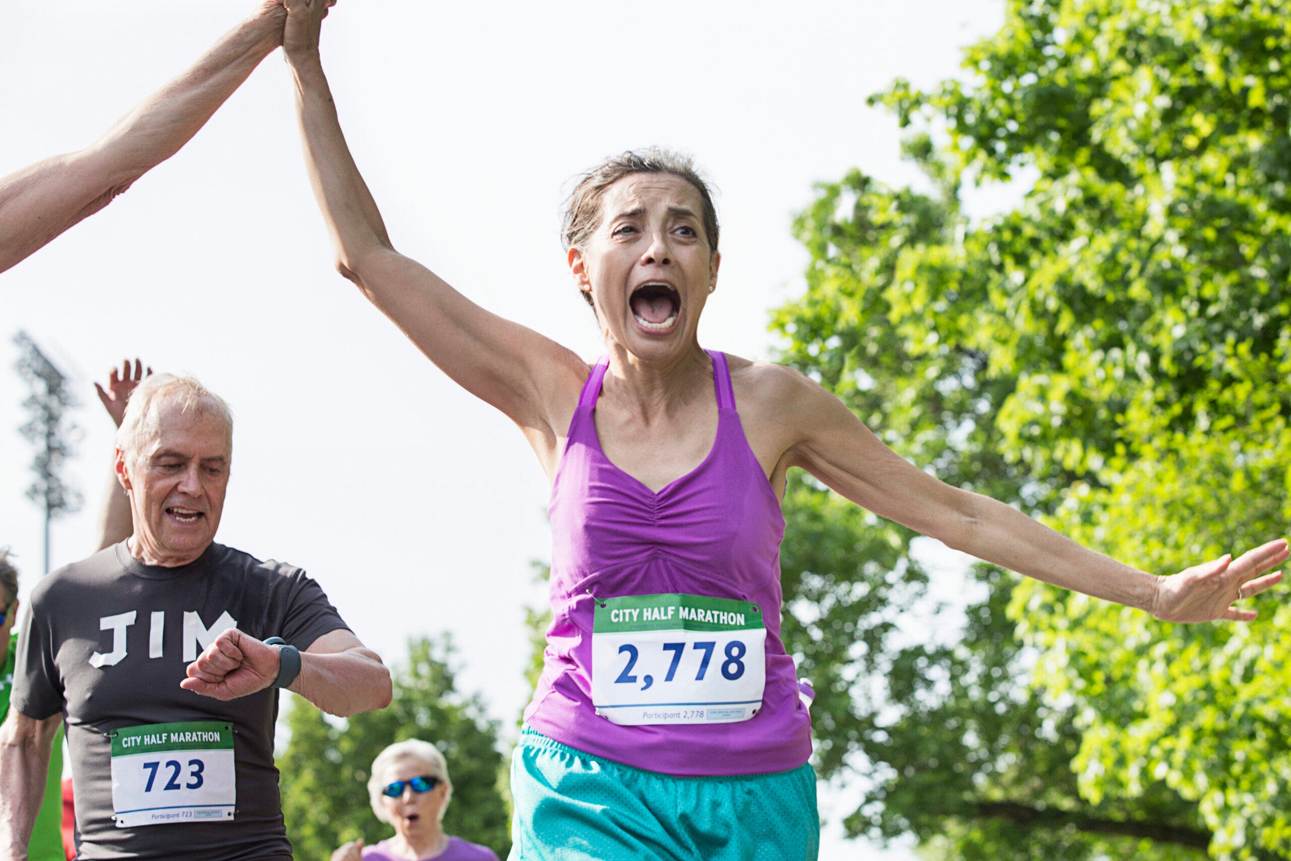 woman excited at the end of a half marathon race