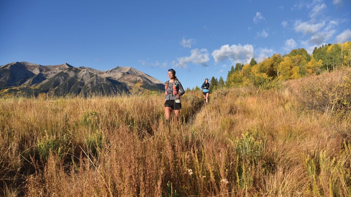 Women run through a mountain meadow during the Crested Butte Ultra