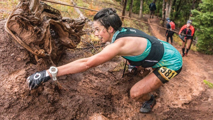 Myke Hermsmeyer 2016 A woman climbs up a muddy slope during Run the Rut