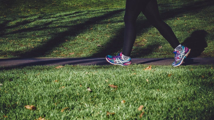 Woman run/walking on a sidewalk