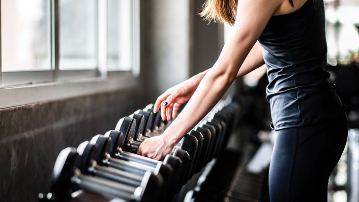 Woman training with dumbbells