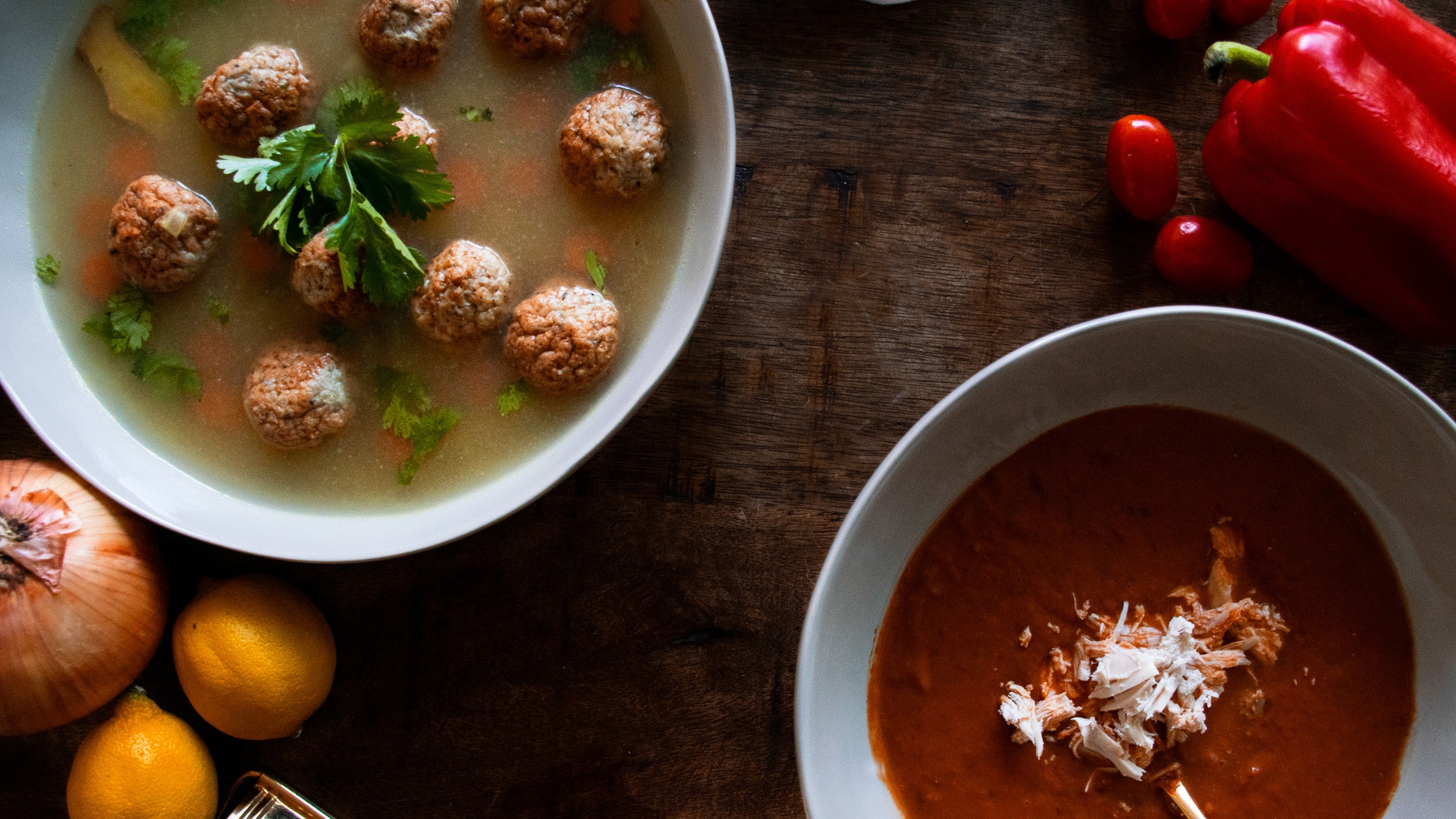 Two types of soup in bowls on a wooden table