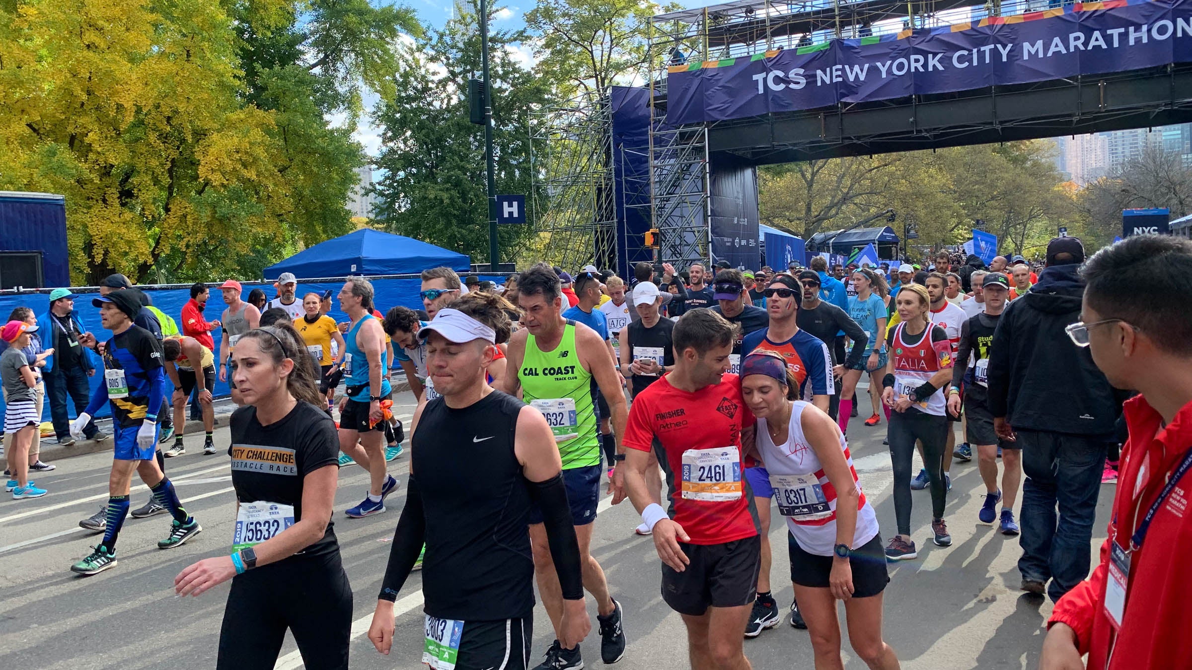 Tired athletes seen walking after crossing the finish line of the New York City Marathon