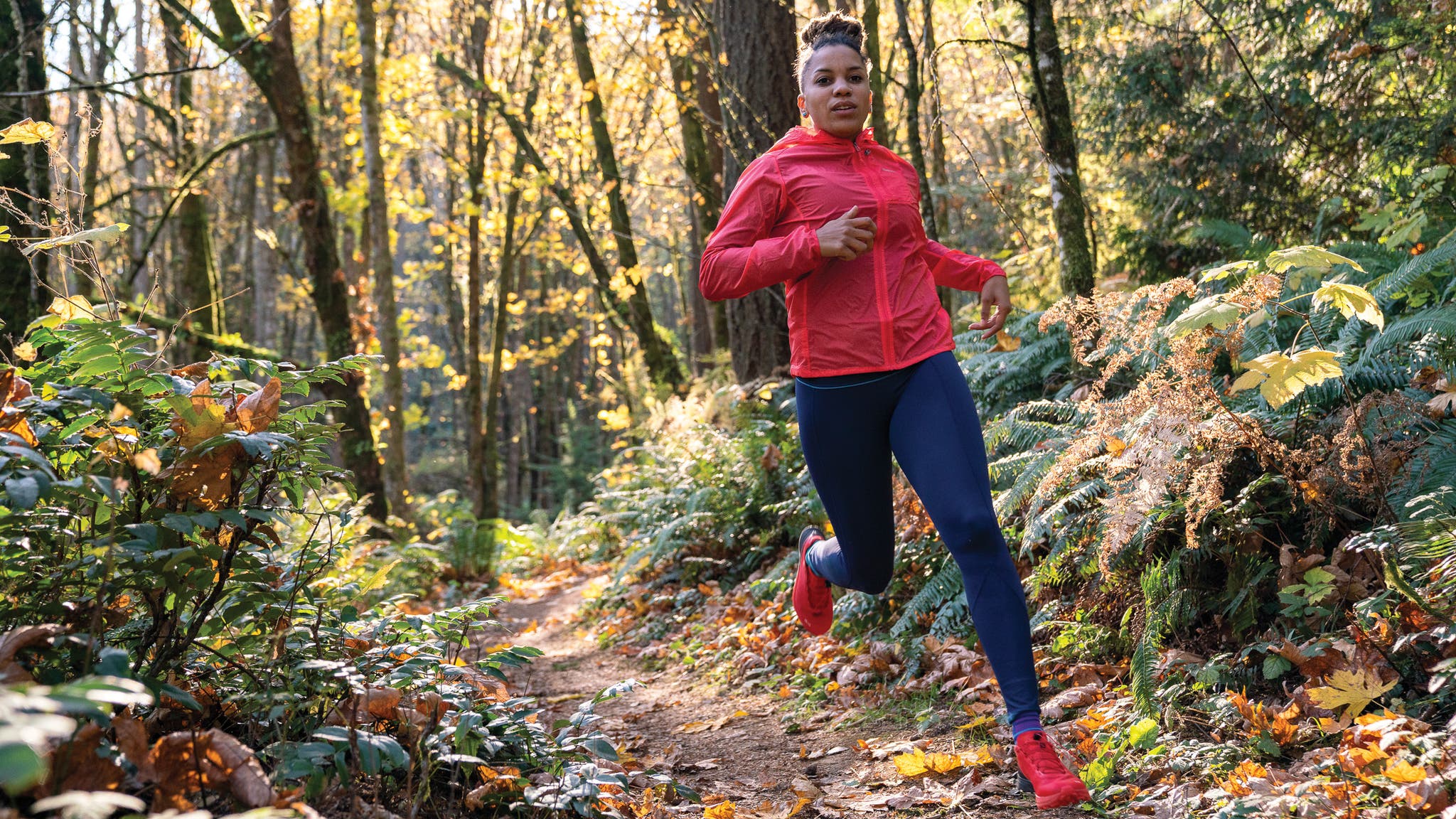 Faith Briggs runs in the woods.