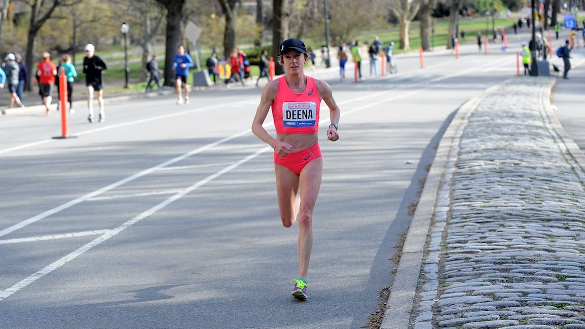 Deena Kastor racing on road marathon in pink kit.
