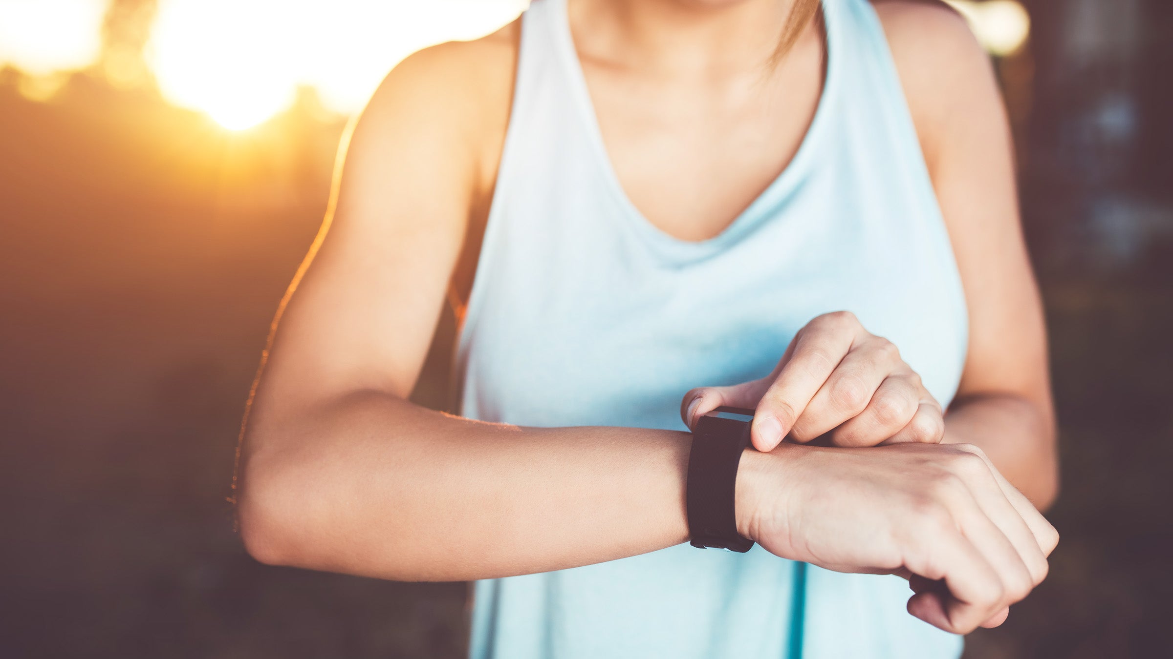 Woman looks at the watch after workout.