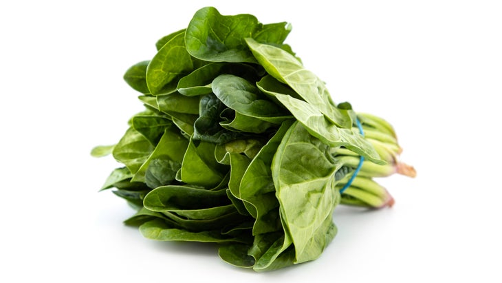 Bunch of spinach leaves on white background