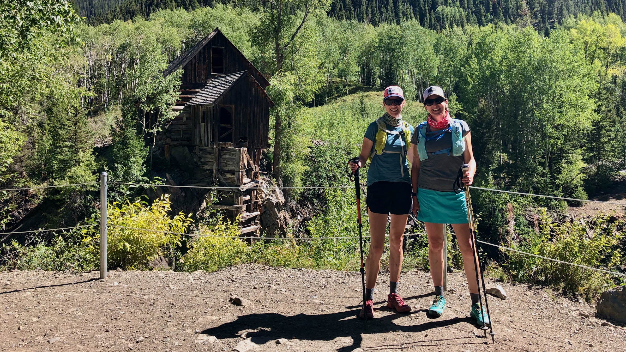 Two women standing in front of the abandoned crystal mill in Colorado
