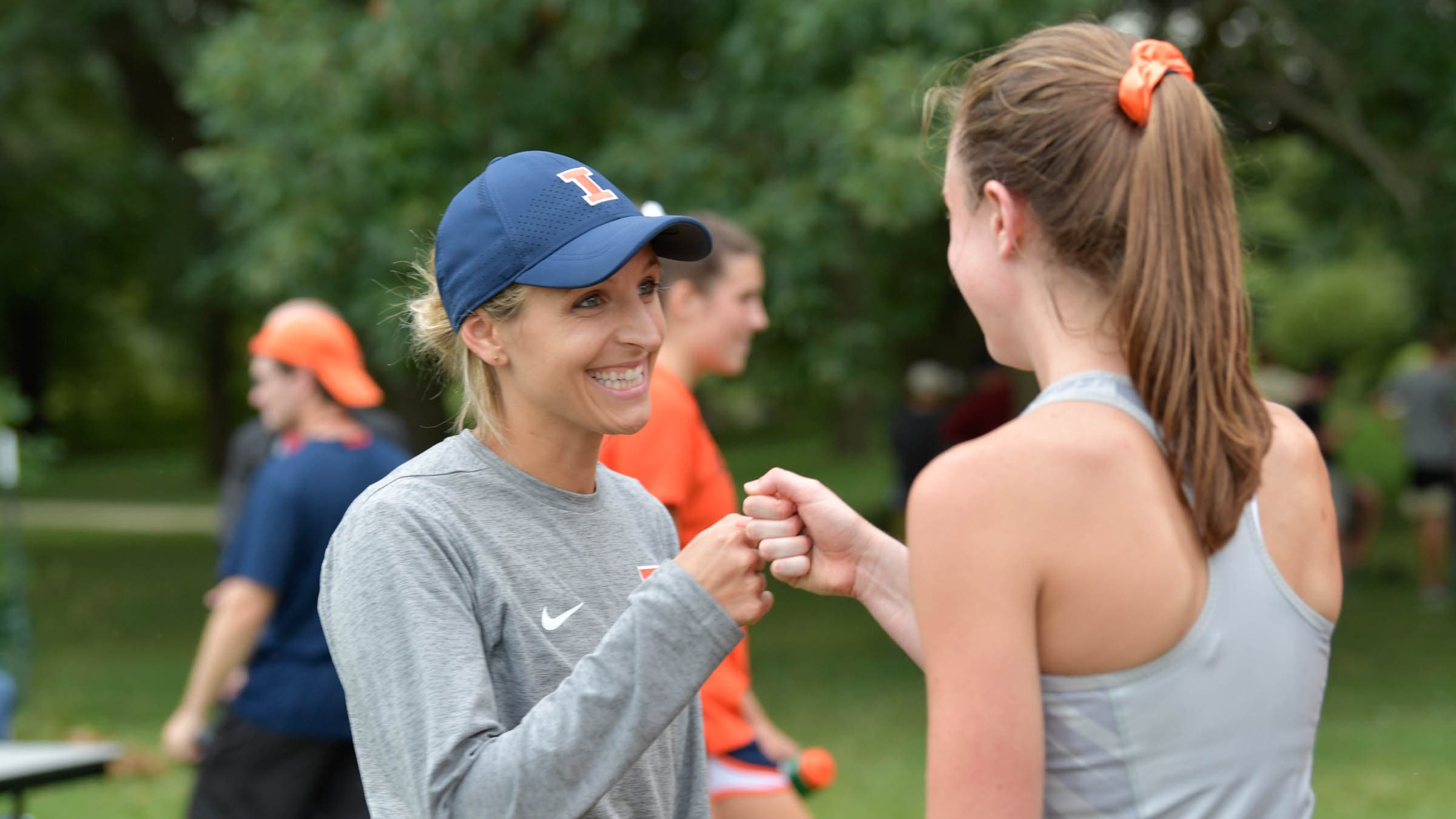 Coach Sarah Haveman gives her runner a fist bump