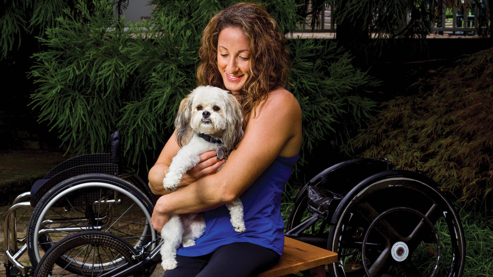 Tatyana McFadden holding her dog at home