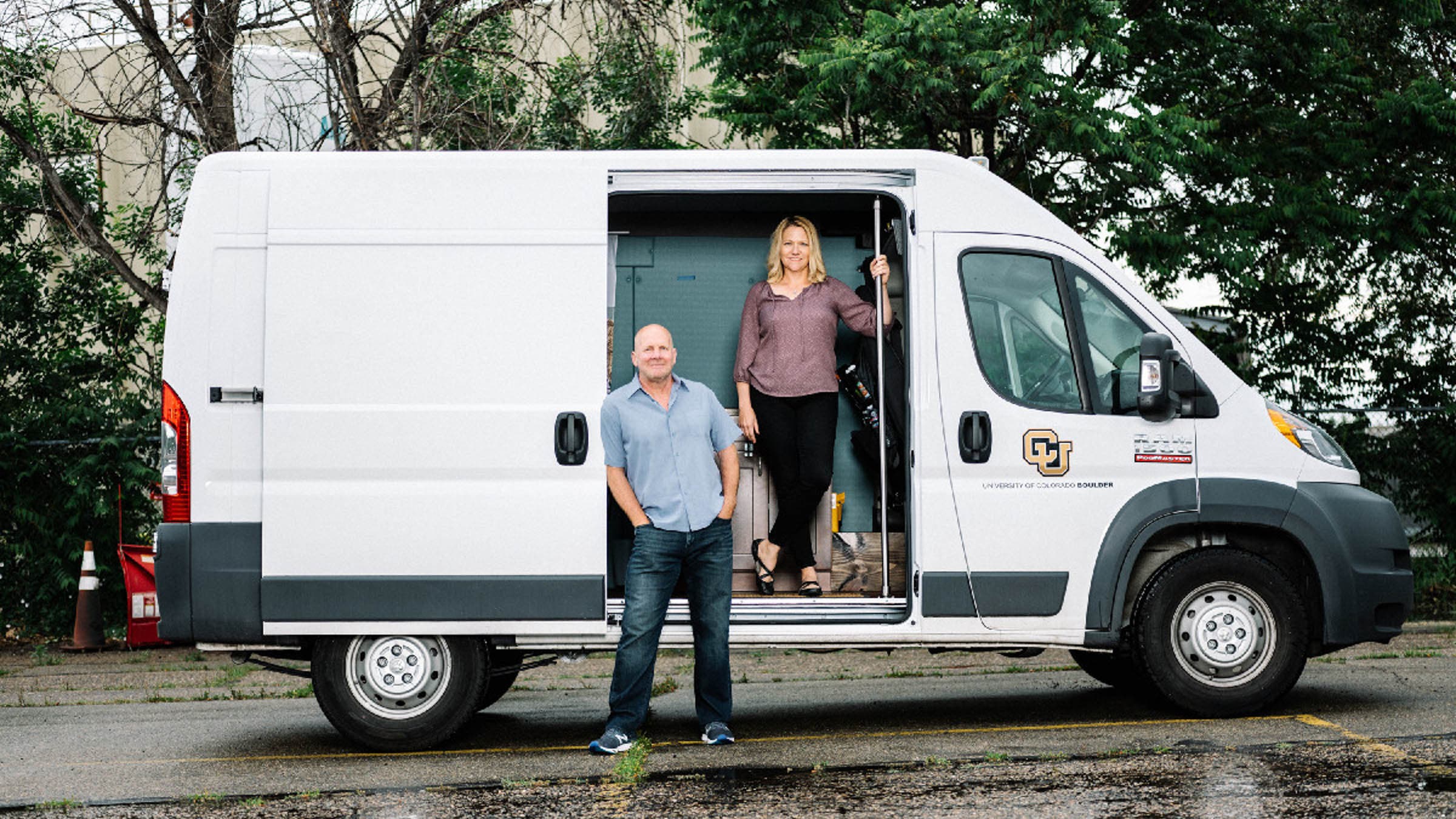 Man and woman standing in front of a white van
