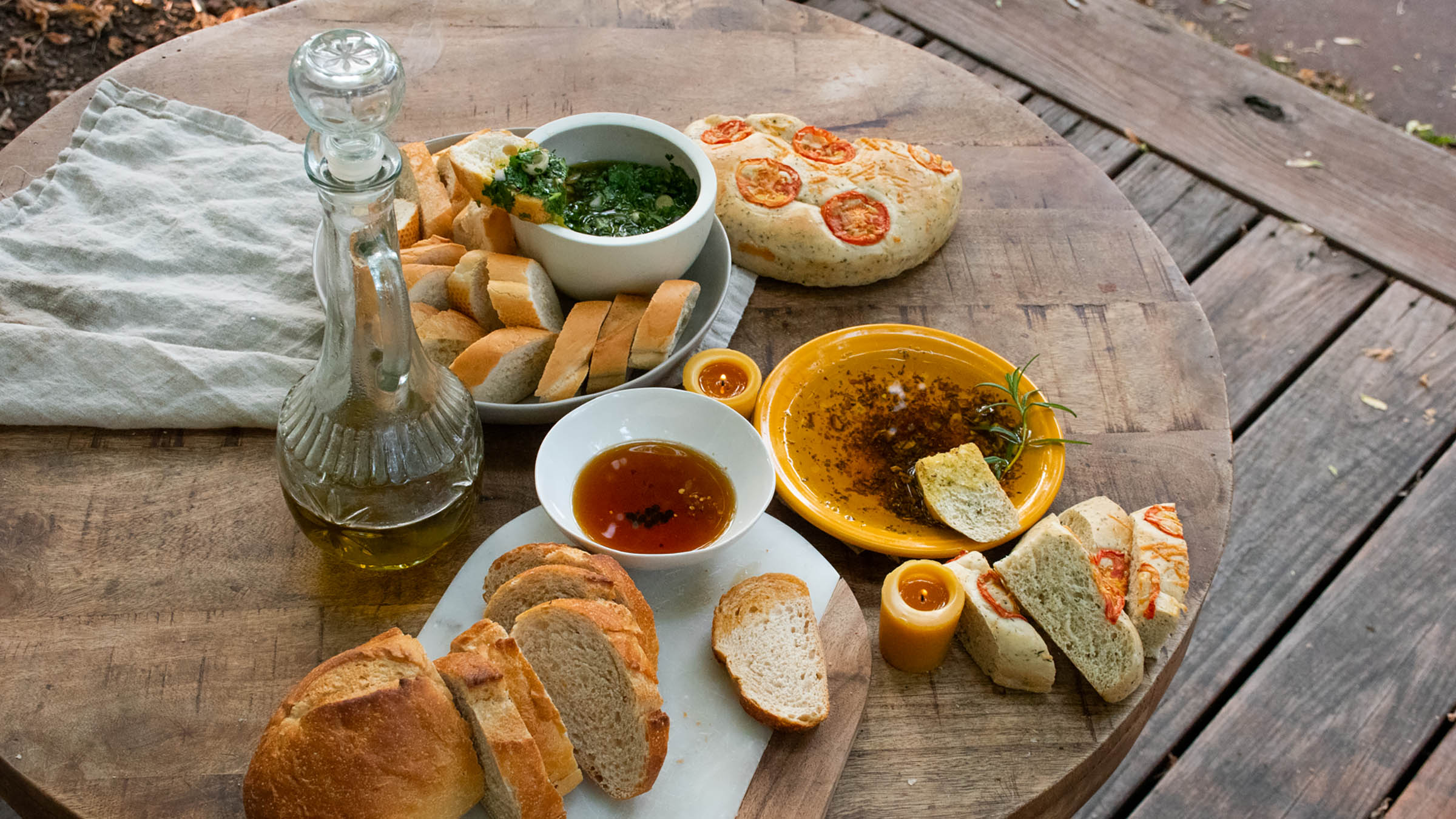 Spread of dips and bread on wooden table