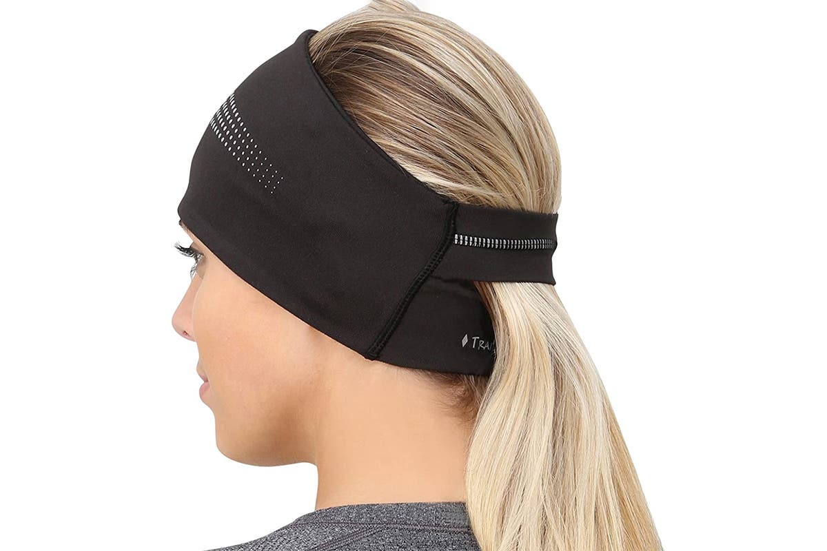 blonde woman with ponytail pulled through running ear warmers