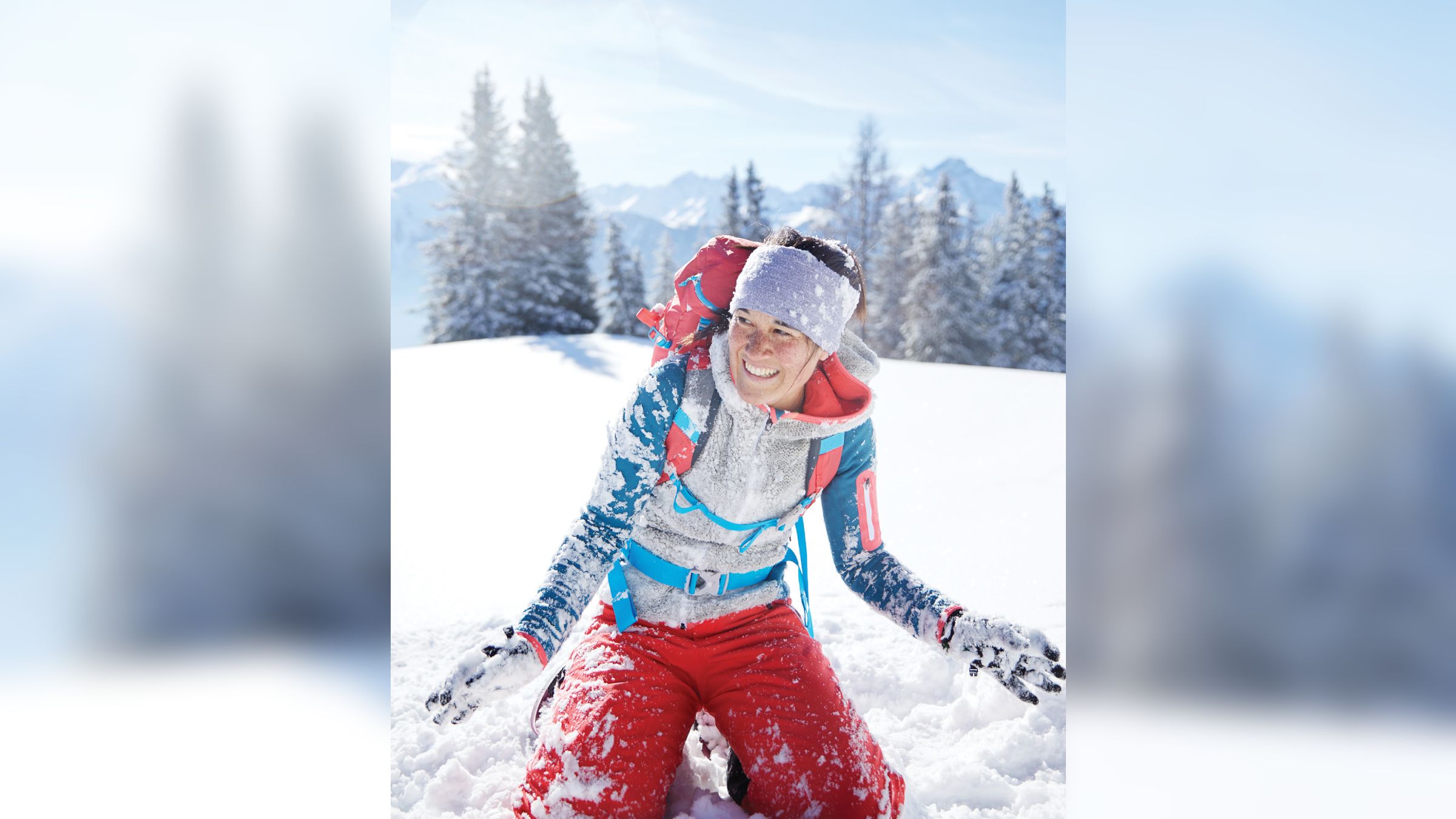Smiling woman sitting in snow