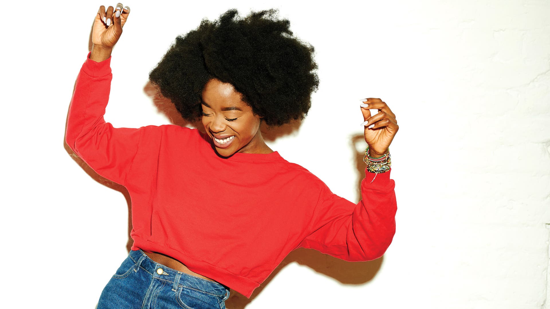 Woman dancing against white backgroun