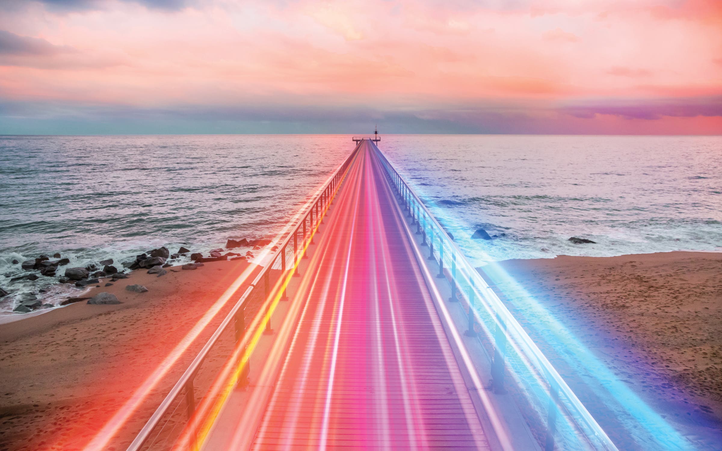 Creative composition of colorful lights trails in motion over the sea.