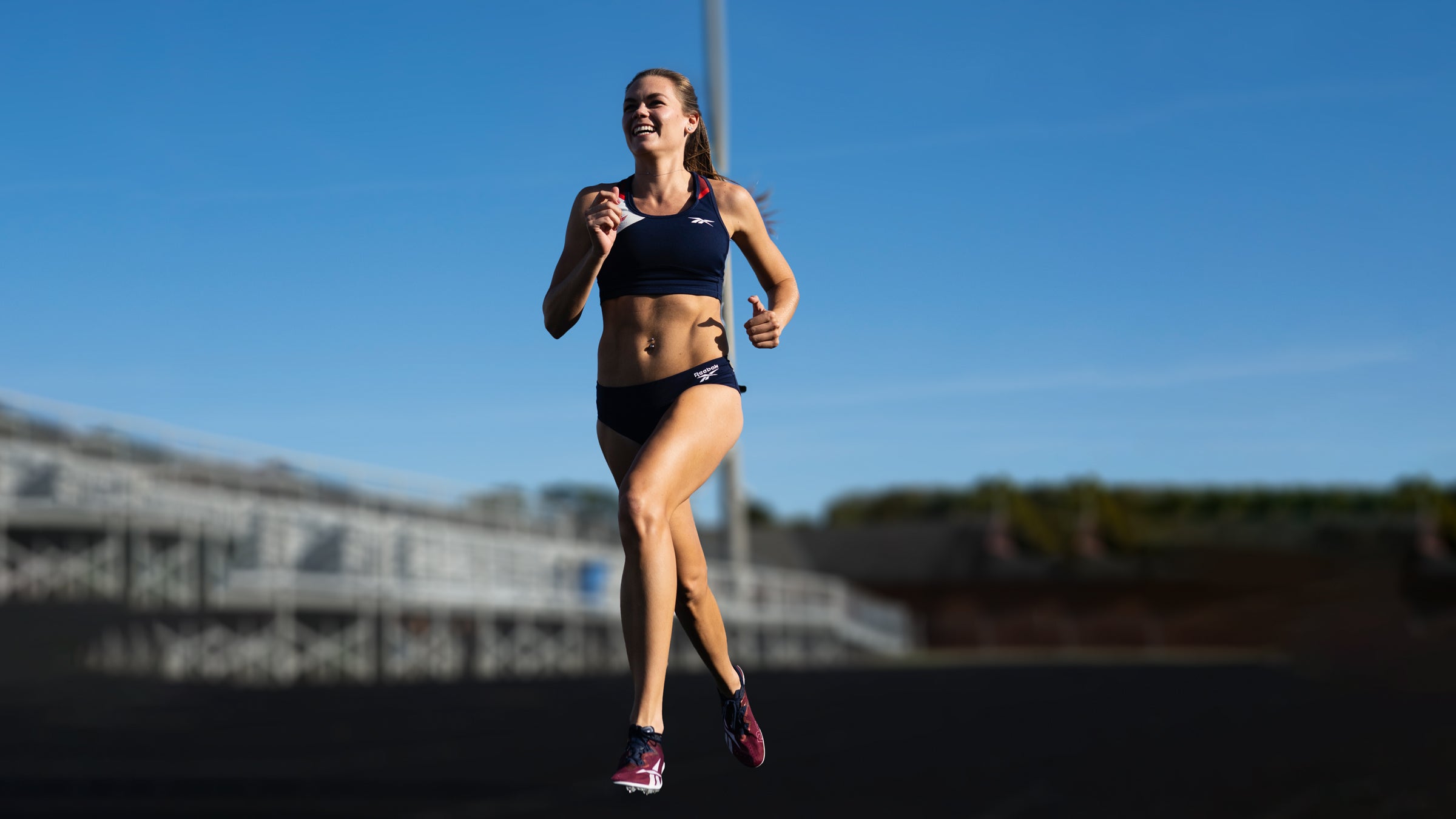 Josette Norris runs outside on a track
