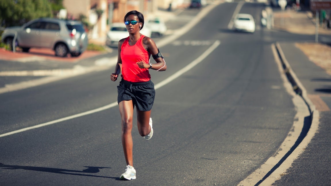 Woman running along a road