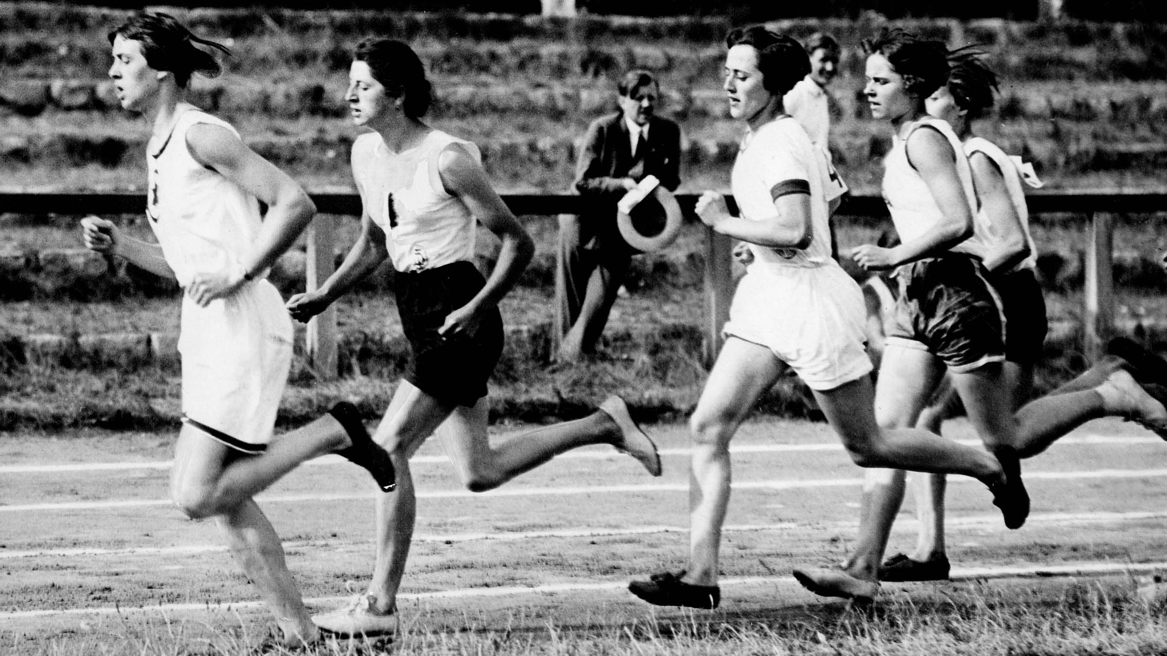 Black and white photo of women running at the first Olympics, making Olympics (and running) history