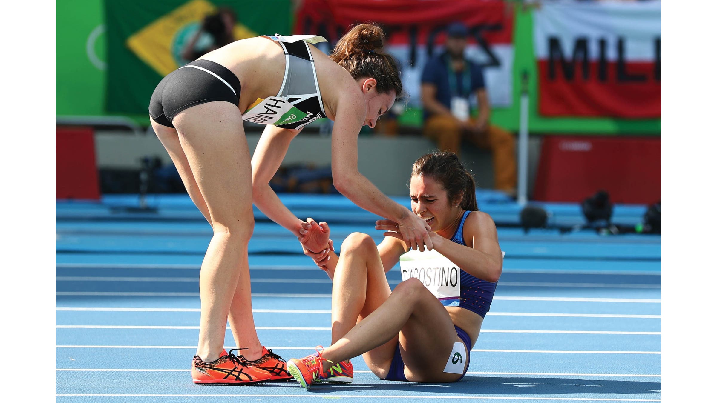 Hamblin helping D'Agostino to her feet