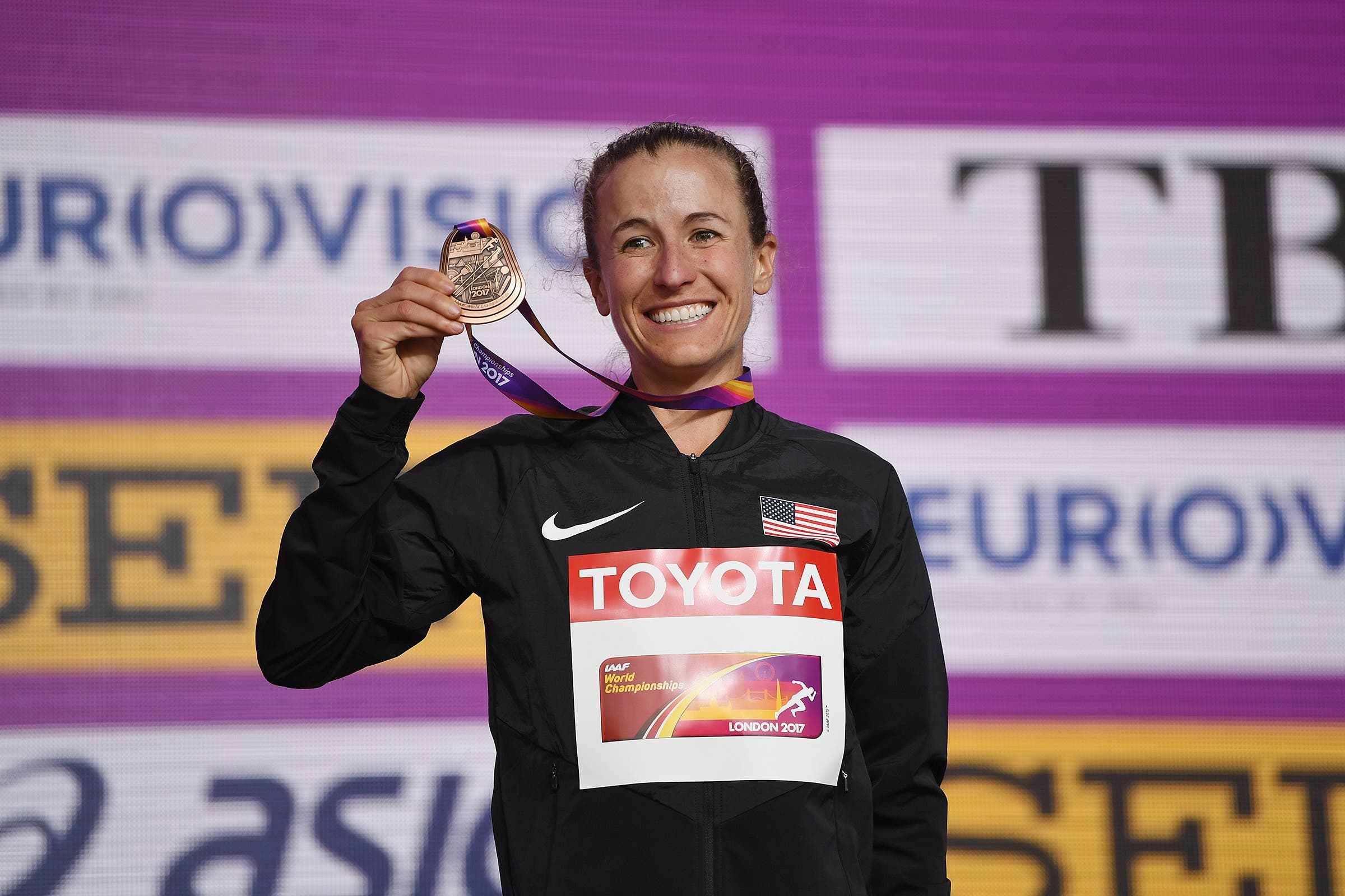 Amy Cragg posing with a bronze medal