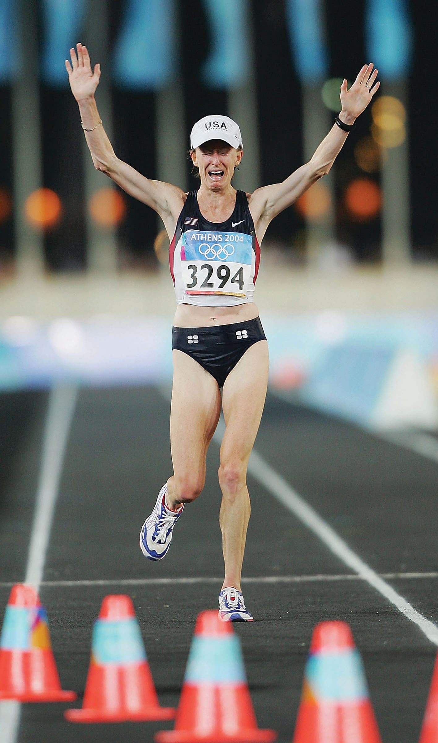 Deena Kastor crosses finish line with her arms held high, crying, in one of the best Olympic moments for women's running