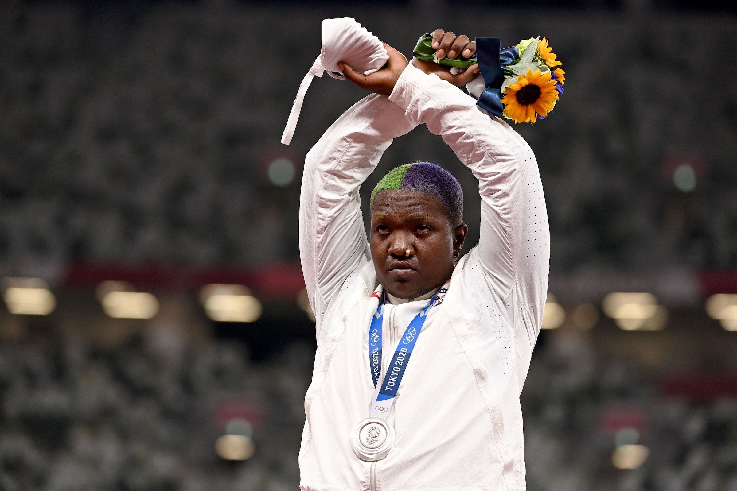 Raven Saunders on the Olympic podium, holding her arms above her head in an X