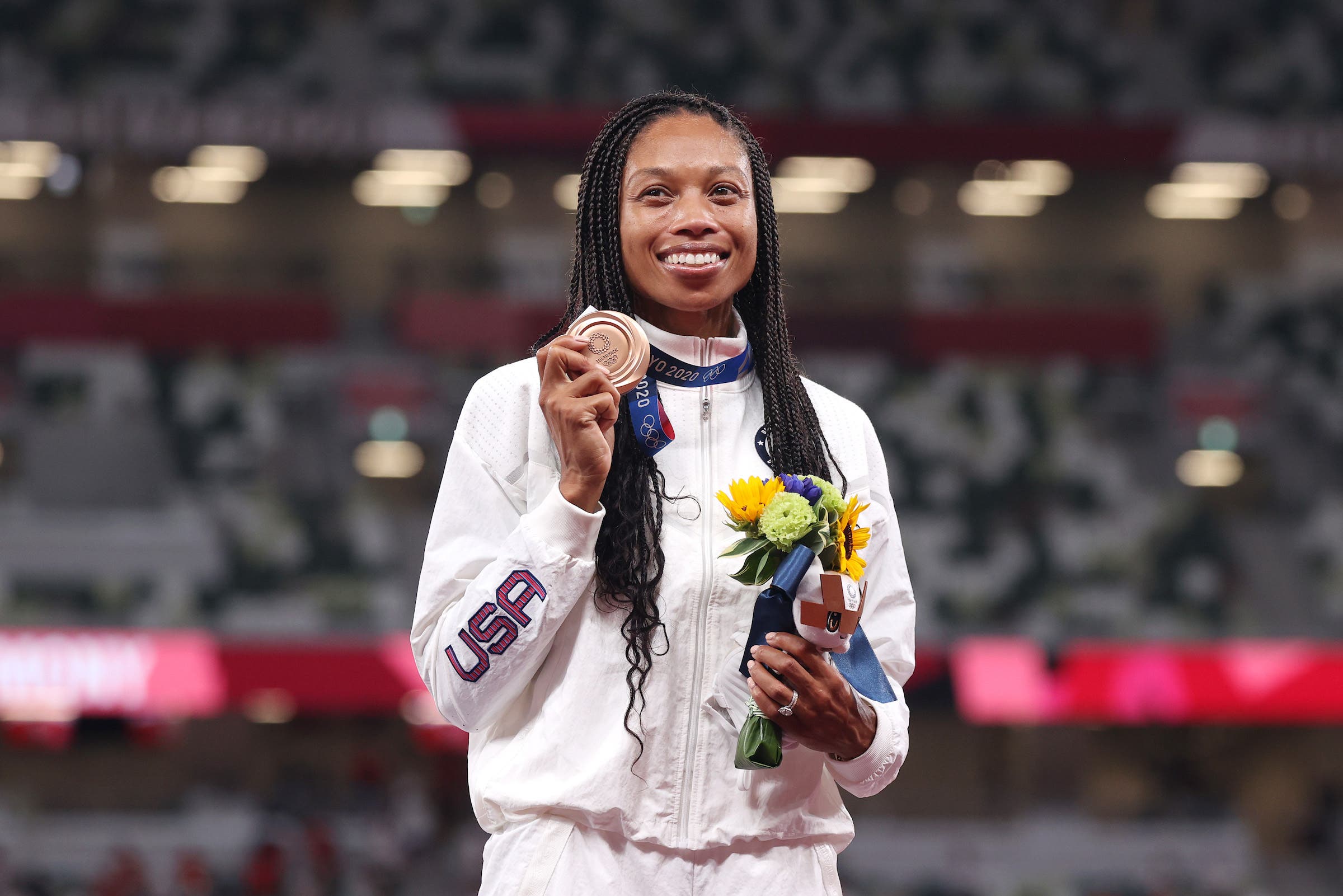TOKYO, JAPAN - AUGUST 06: Bronze medalist Allyson Felix of Team USA holds up her medal on the podium during the medal ceremony for the Women's 400m on day fourteen of the Tokyo 2020 Olympic Games at Olympic Stadium on August 06, 2021 in Tokyo, Japan. (Photo by Christian Petersen/Getty Images)