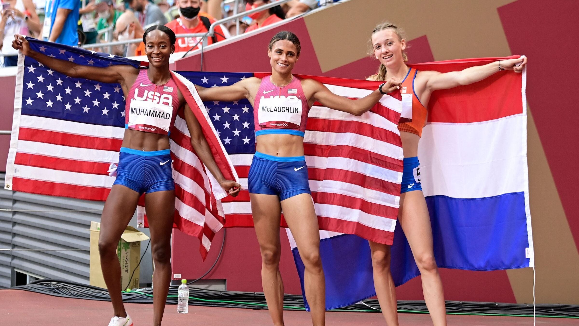 USA's Sydney Mclaughlin (C) celebrates after winning the women's 400m hurdles final setting a new world record with silver medalist USA's Dalilah Muhammad (L) and bronze medalist Netherlands' Femke Bol during the Tokyo 2020 Olympic Games at the Olympic Stadium in Tokyo on August 4, 2021. (Photo by Javier SORIANO / AFP) (Photo by JAVIER SORIANO/AFP via Getty Images)