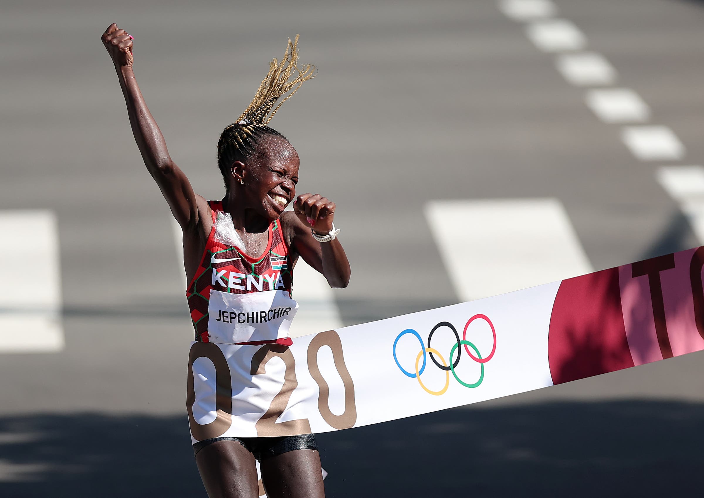 KAWAGOE, JAPAN - AUGUST 07: Peres Jepchirchir of Team Kenya celebrates as she crosses the finish line to win the gold medal in the Women's Marathon Final on day fifteen of the Tokyo 2020 Olympic Games at Kasumigaseki Country Club on August 07, 2021 in Kawagoe, Japan. (Photo by Lintao Zhang/Getty Images)