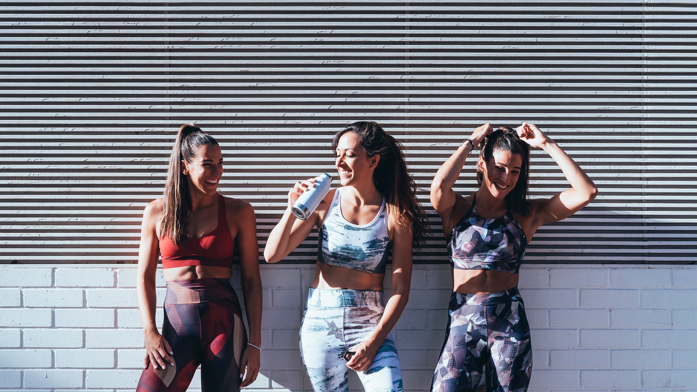 Three happy female runners after a recovery run, which can be done with friends at a conversational pace