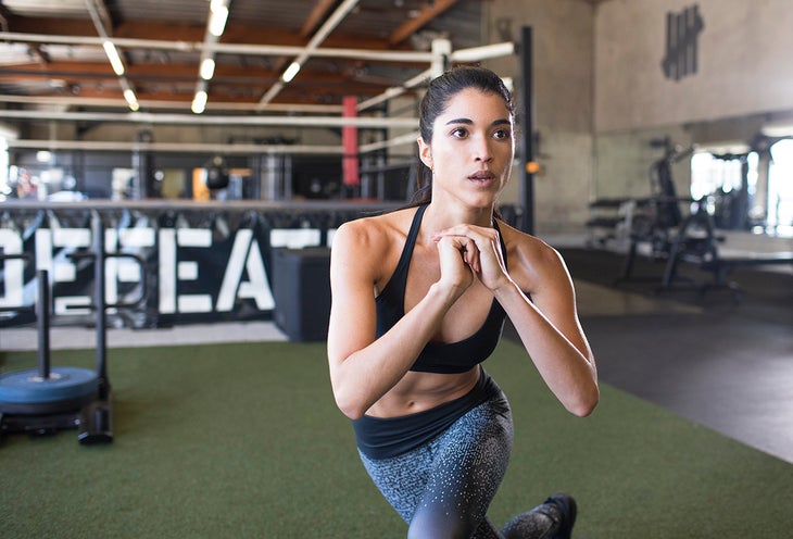 woman doing forward lunges with a twist, a good back exercise for runners