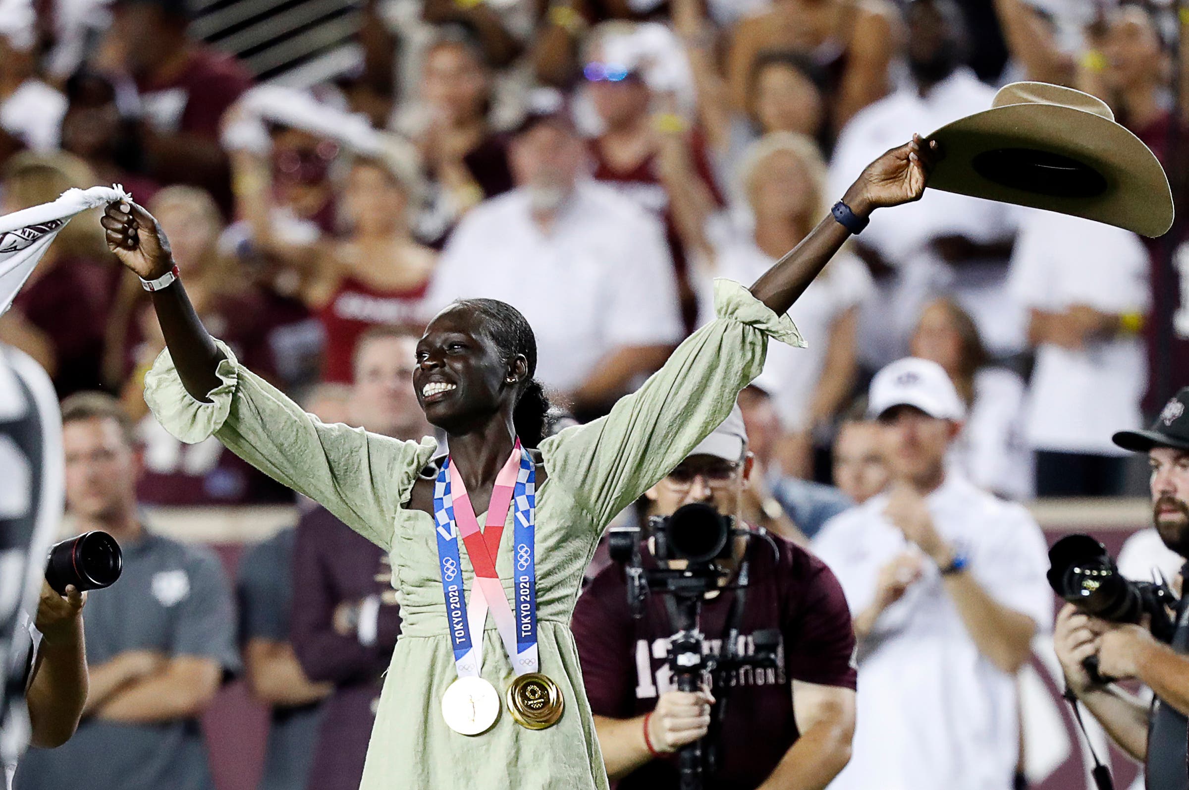 Athing Mu celebrating at a football game