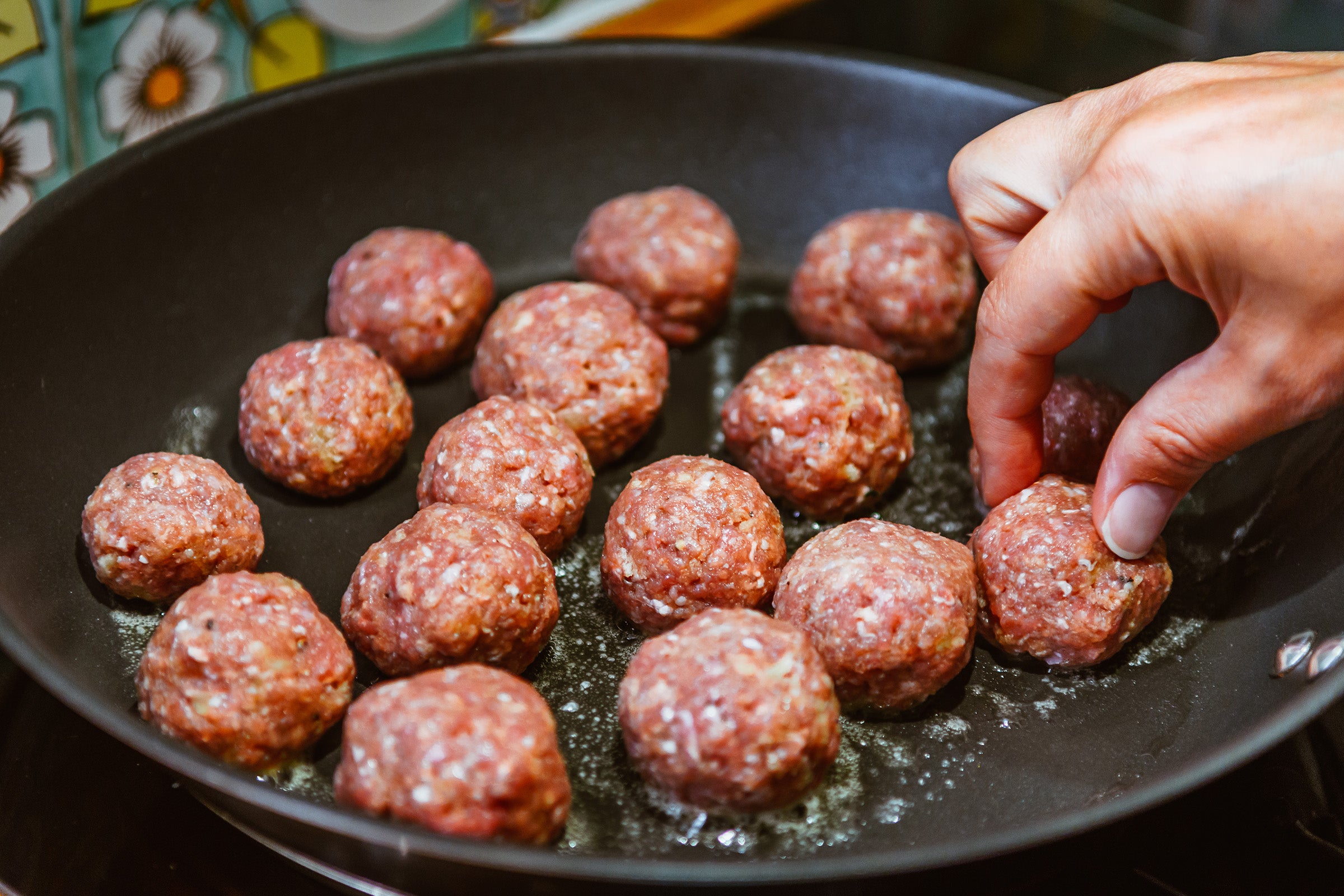 woman pan cooking meatballs, an easy weeknight meal for runners