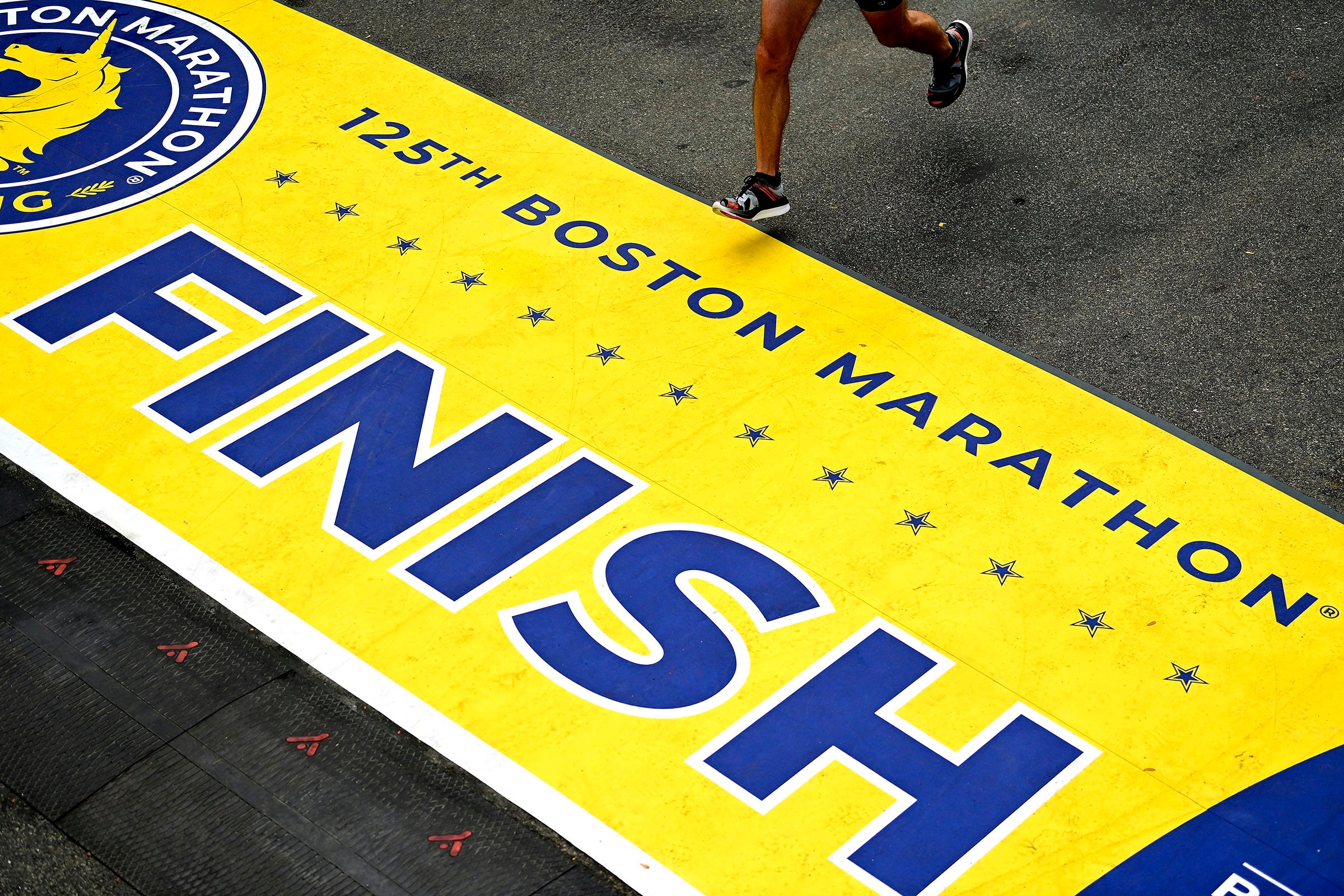 BOSTON, MASSACHUSETTS - OCTOBER 11: A runner crosses the finish line during the 125th Boston Marathon on October 11, 2021 in Boston, Massachusetts. 