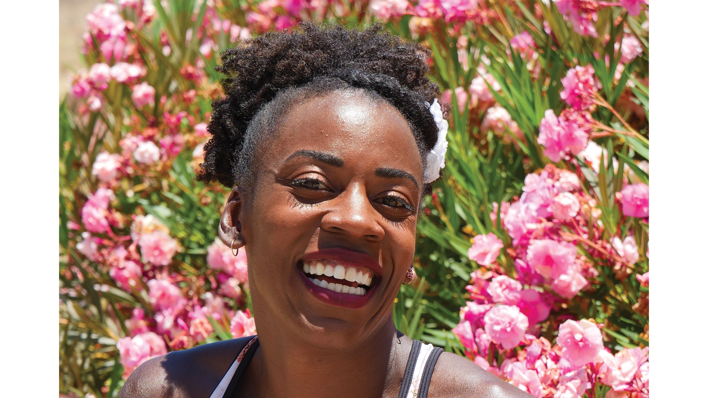 Alysia Montano laughing in front of flowers