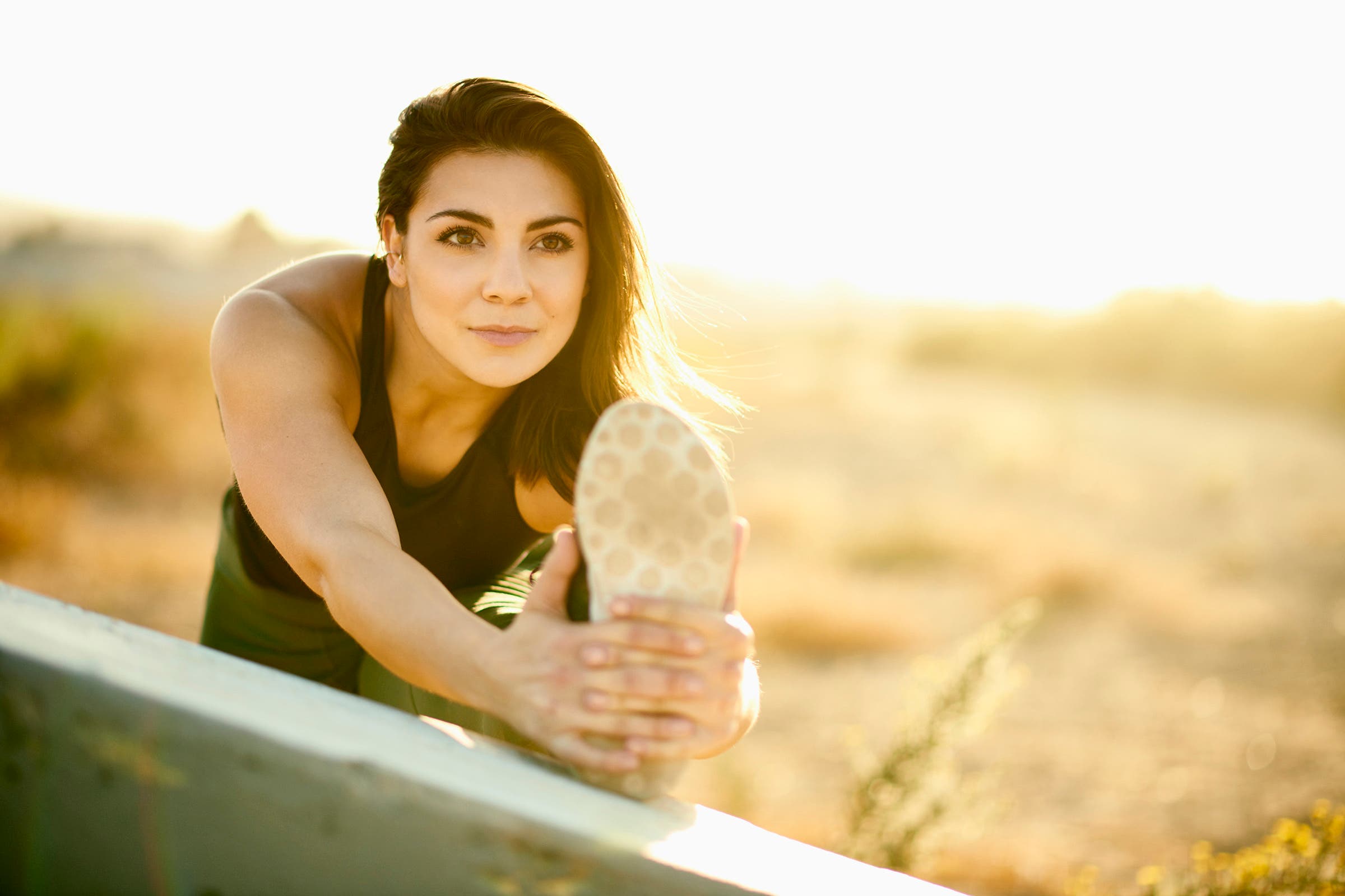 woman stretching before a run, trying to set new expectations and rekindle her love of running