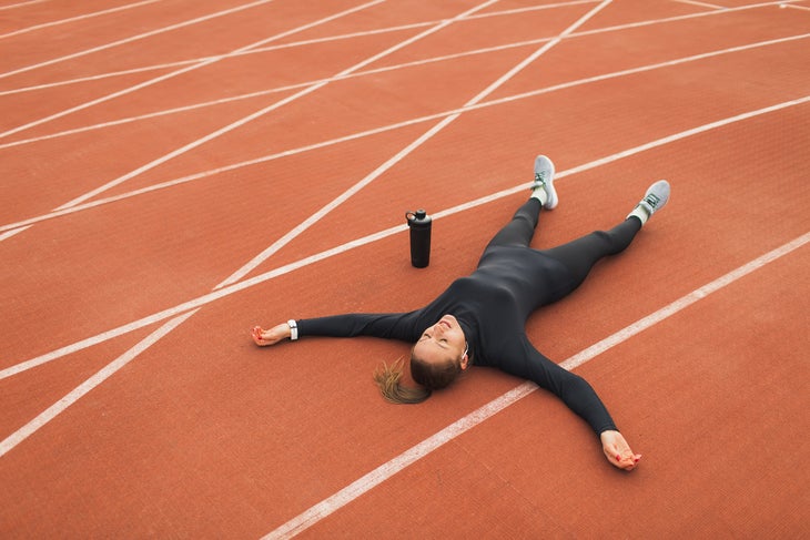 woman exhausted during a run from symptoms of overtraining