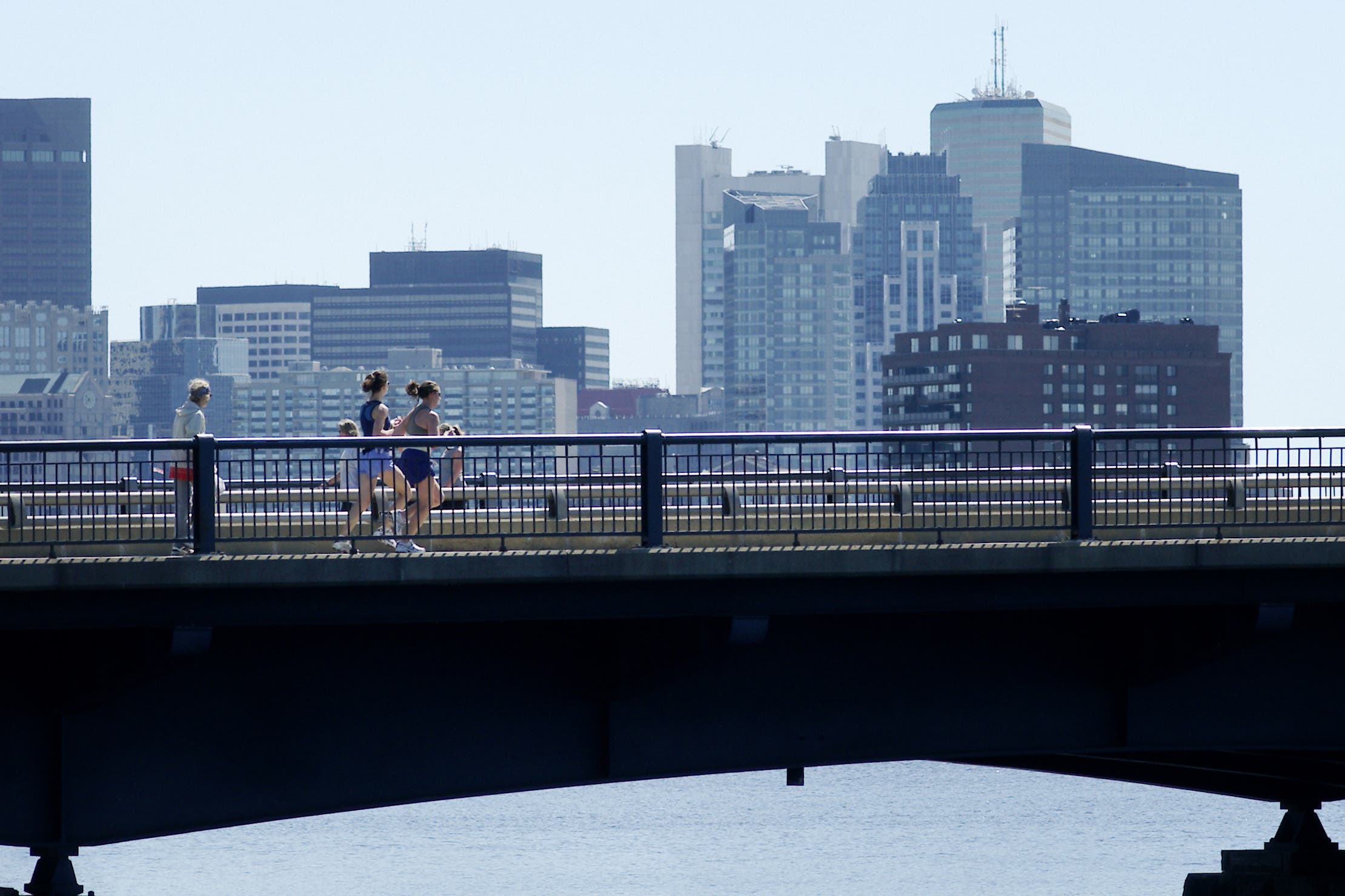 Women running over Charles River in Boston