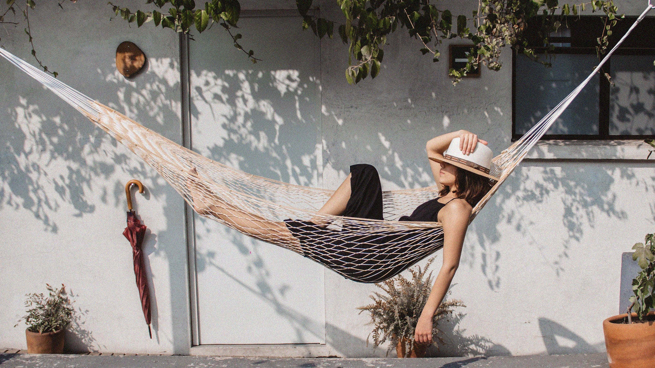 woman relaxing in a hammock in the sun during a recovery week from running