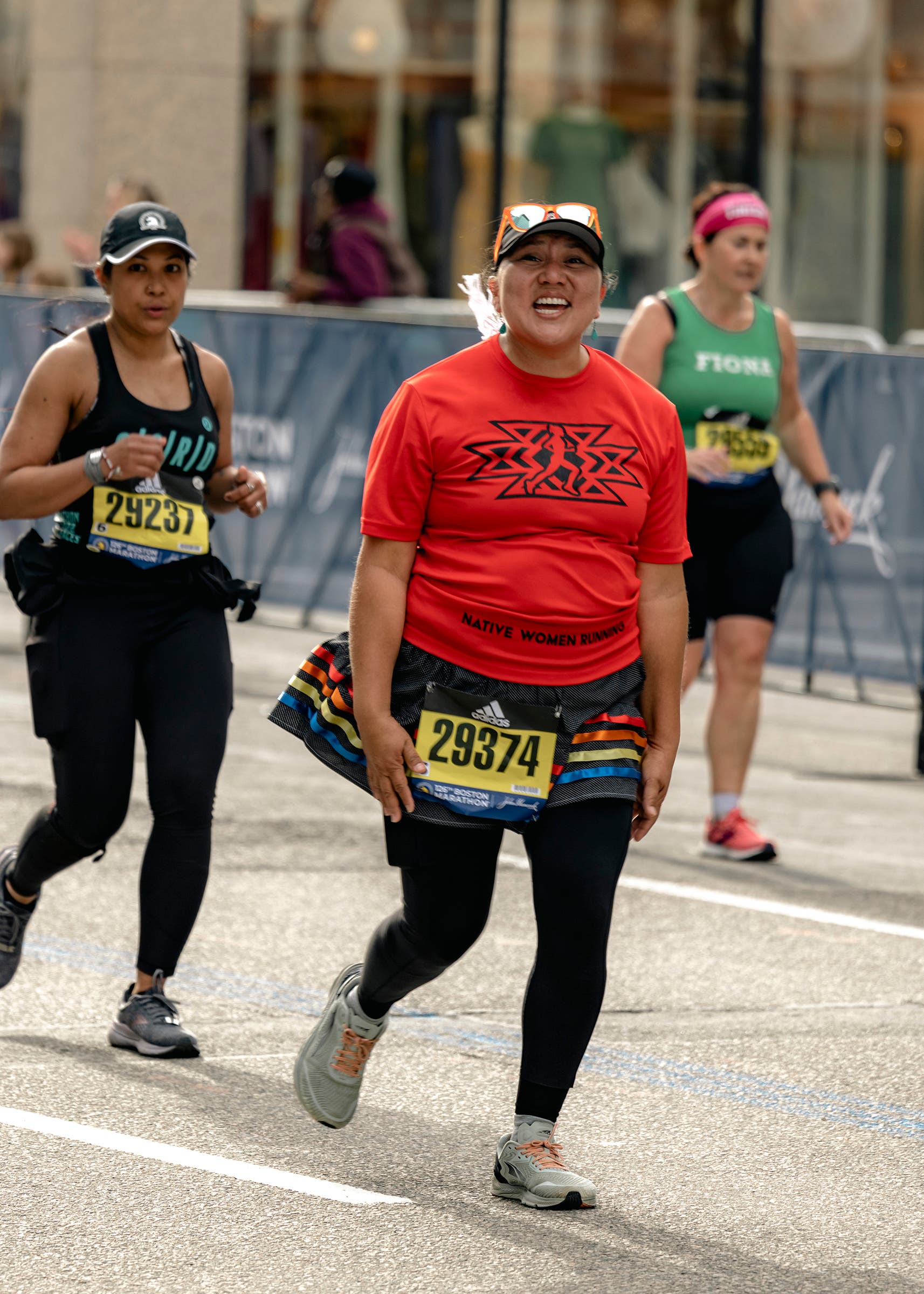 Angel Tadytin during the Boston Marathon smiles at mile 25