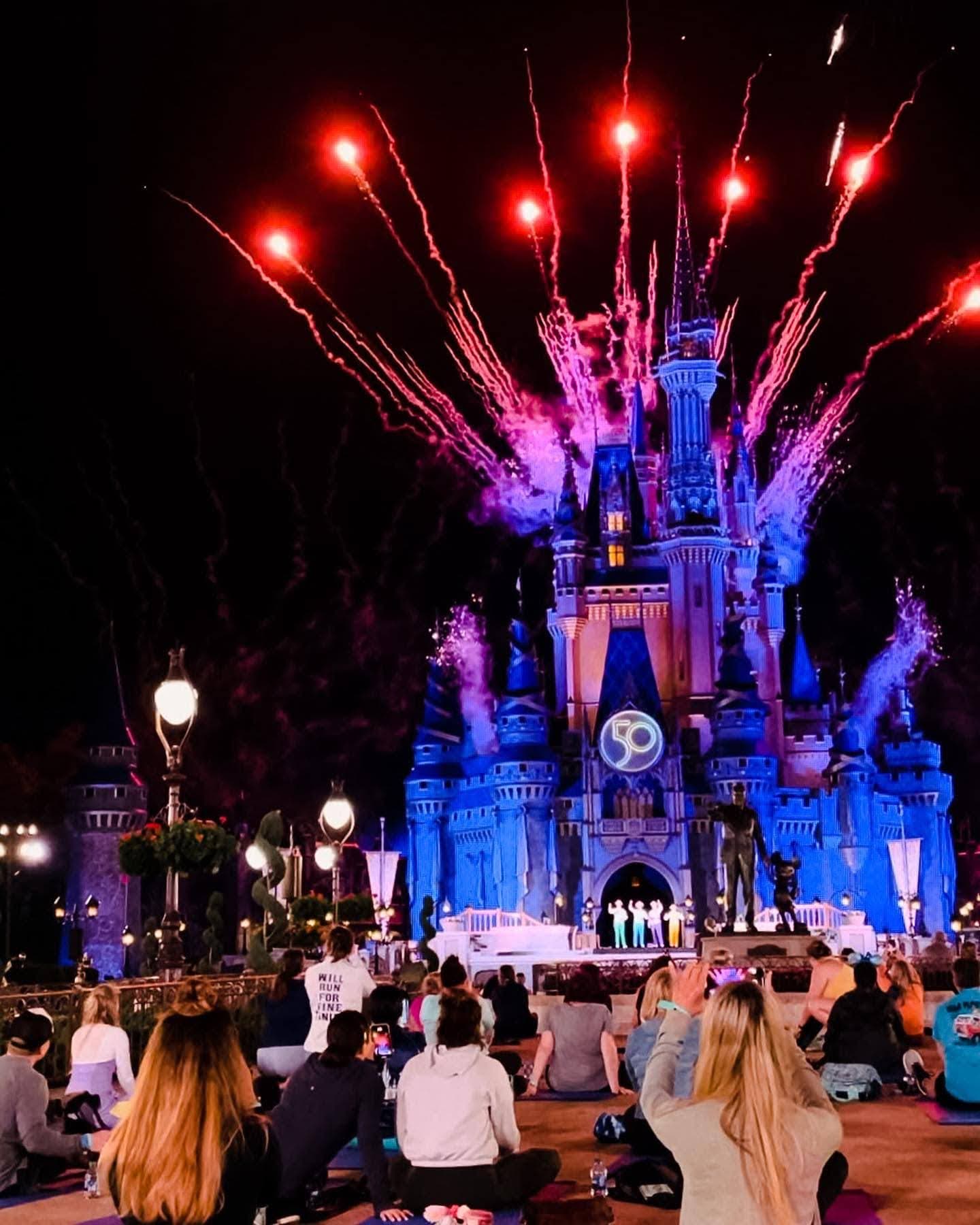 fireworks explode behind Cinderella's castle at Disney World during the Springtime Surprise Weekend